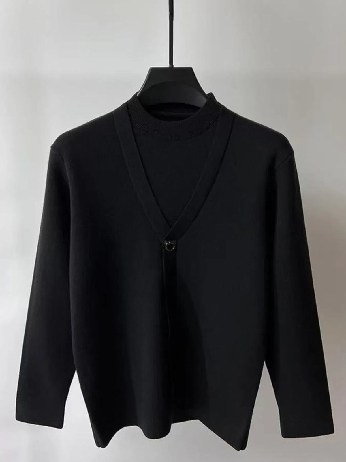 Black knit long-sleeve sweater with V-neck wrap and ring-loop chest closure