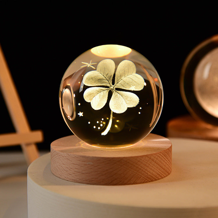 Galaxy crystal ball table lamp with illuminated flower/star pattern inside glass globe