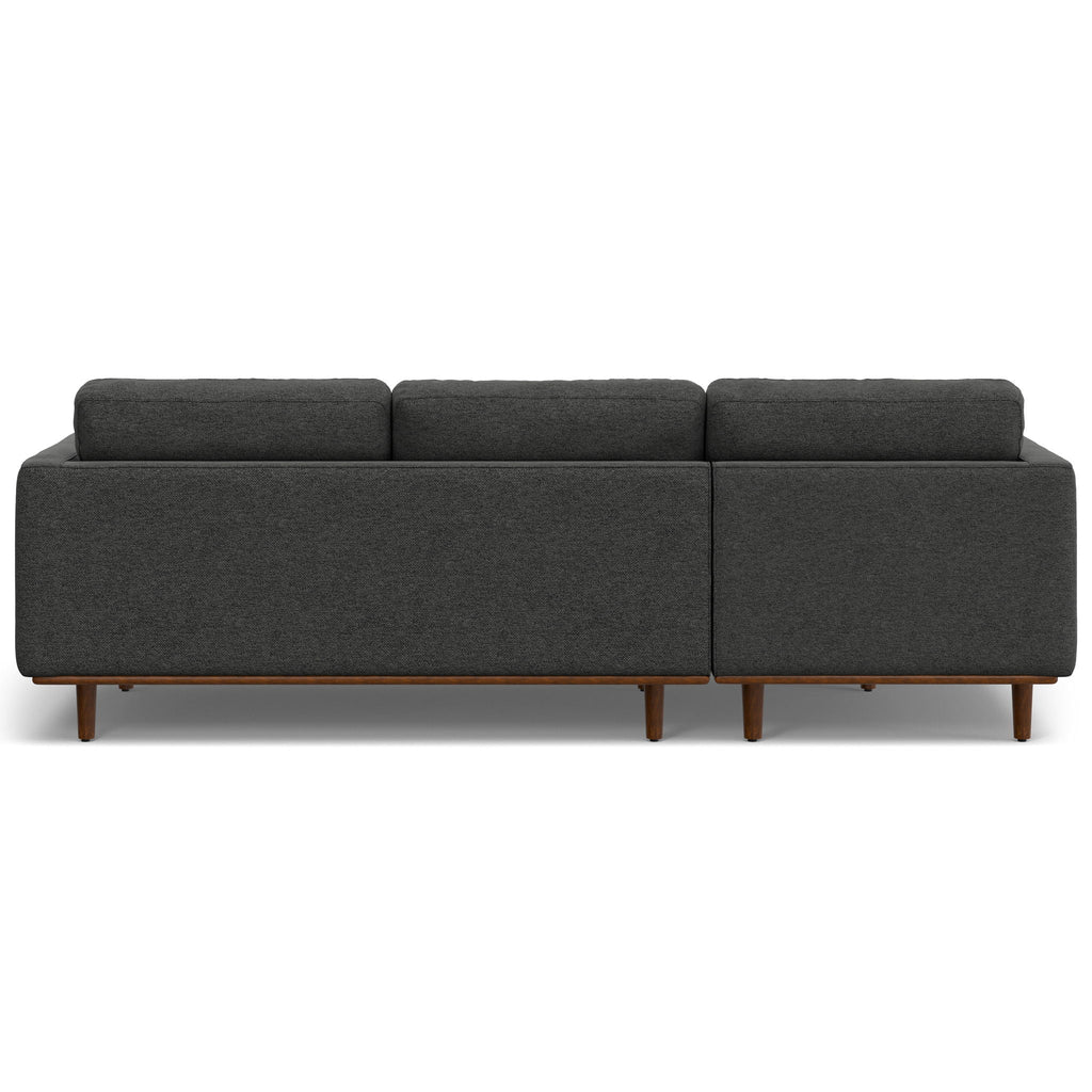 Dark gray upholstered sectional sofa with boxy armrests and wooden legs