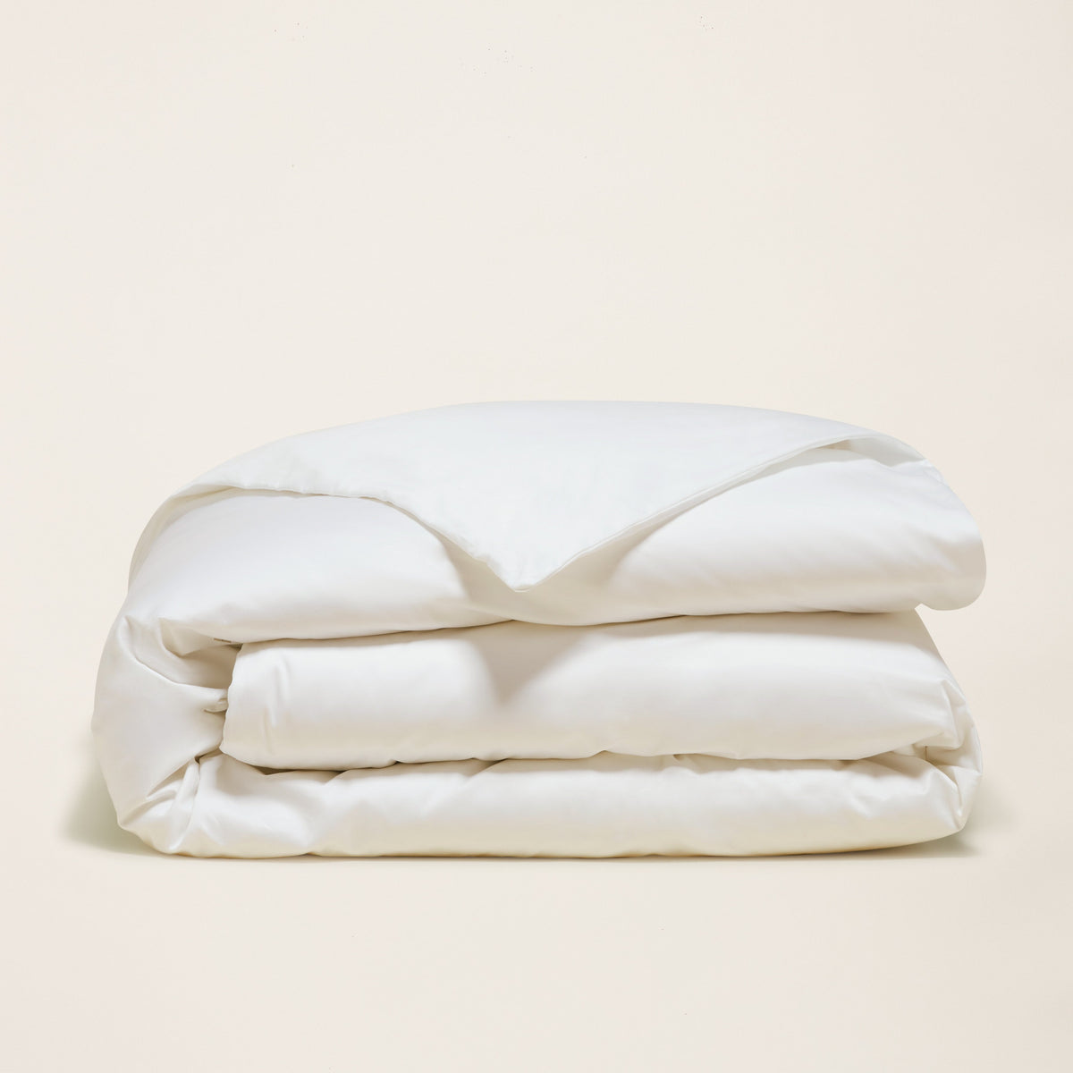 Folded white comforter or duvet with smooth fabric