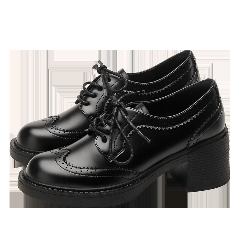 Black lace-up chunky heel shoes with round toe and decorative wingtip stitching.