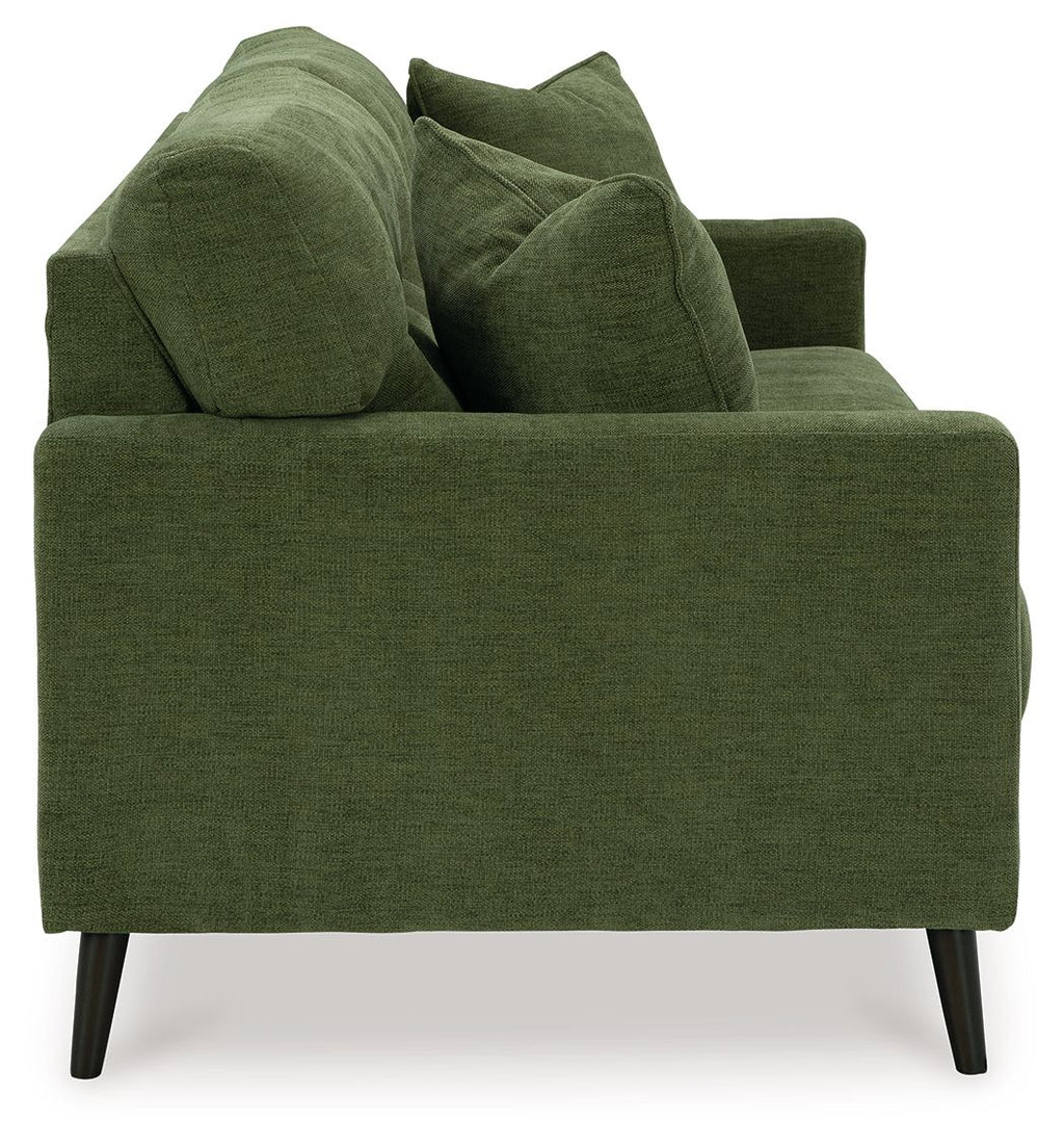 Green upholstered sofa close-up from side with textured fabric and back pillows