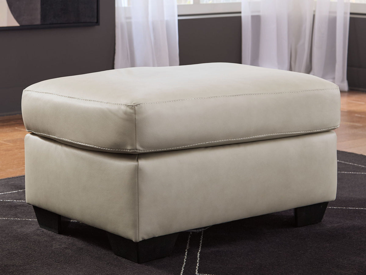 Cream upholstered ottoman with stitched top cushion and dark block legs