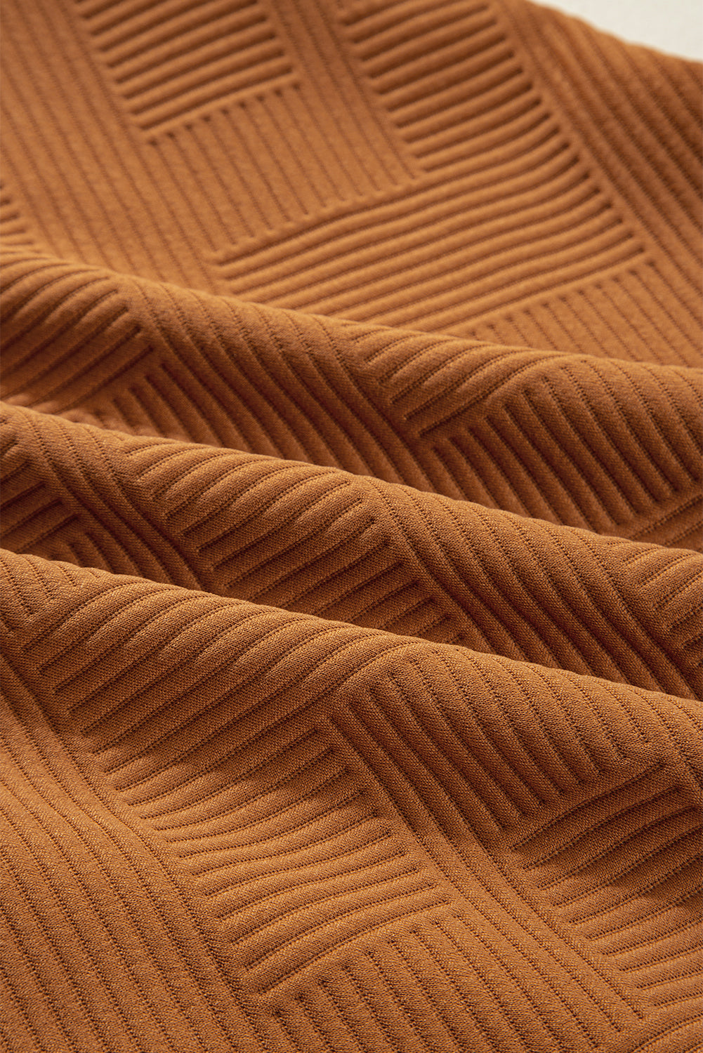 Close-up of desert gold textured fabric with geometric rib pattern