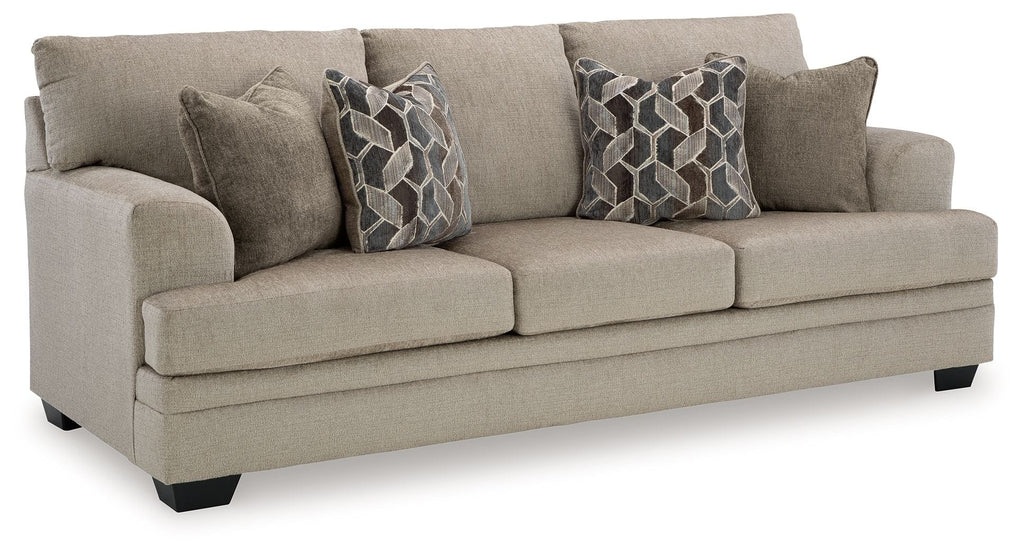Upholstered sofa in light gray fabric with two patterned throw pillows and square arms