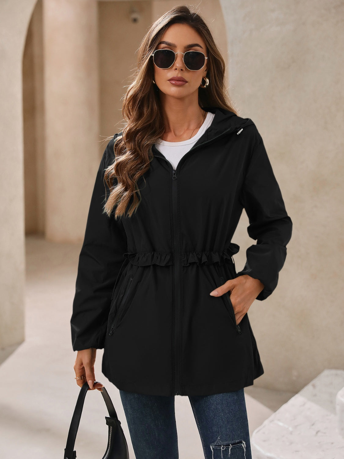 Black hooded windbreaker jacket with zip closure and elasticized waist