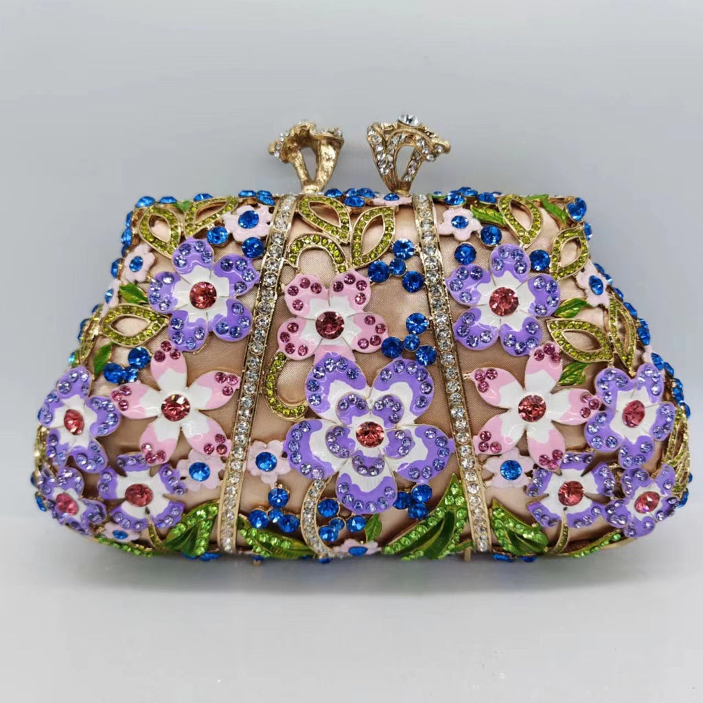 Front view of ornate floral clutch bag with blue crystals, pink blossoms, and gold-tone beading