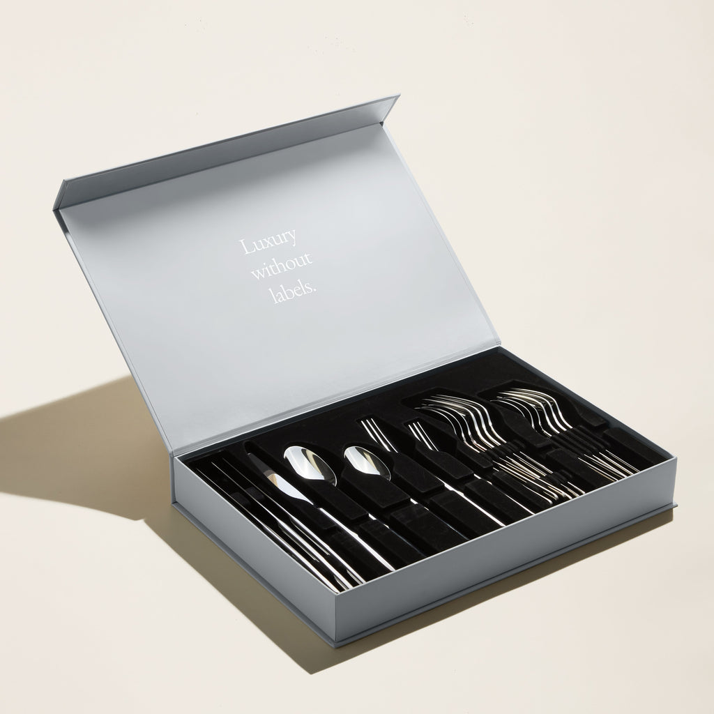 Silver mirror-finish flatware set in open gift box tray
