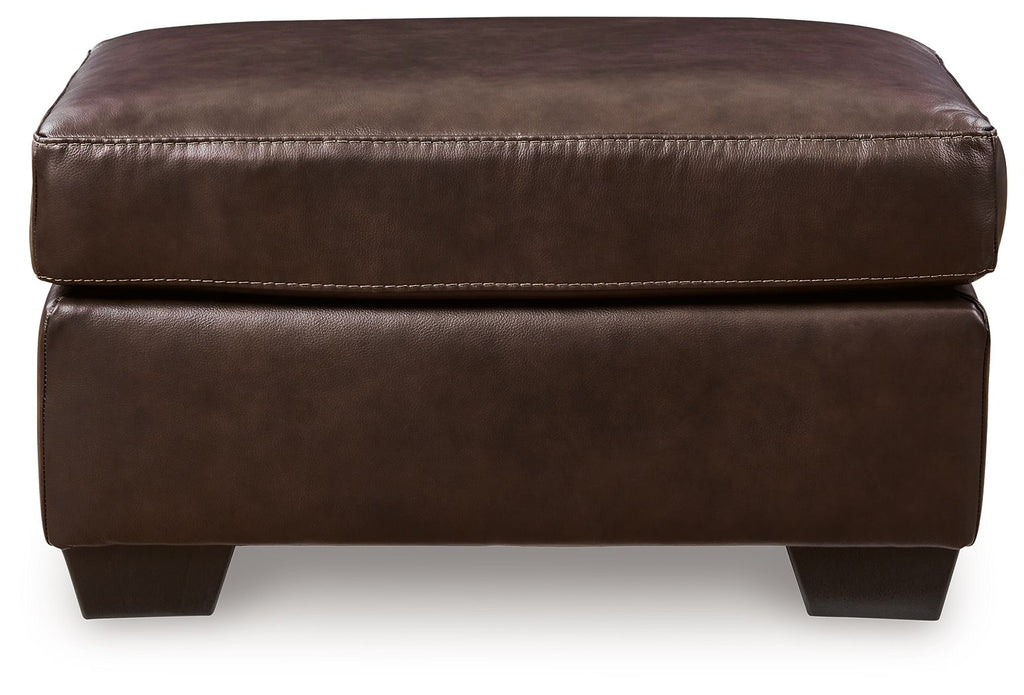 Dark brown padded ottoman with stitched top seam and dark square tapered legs