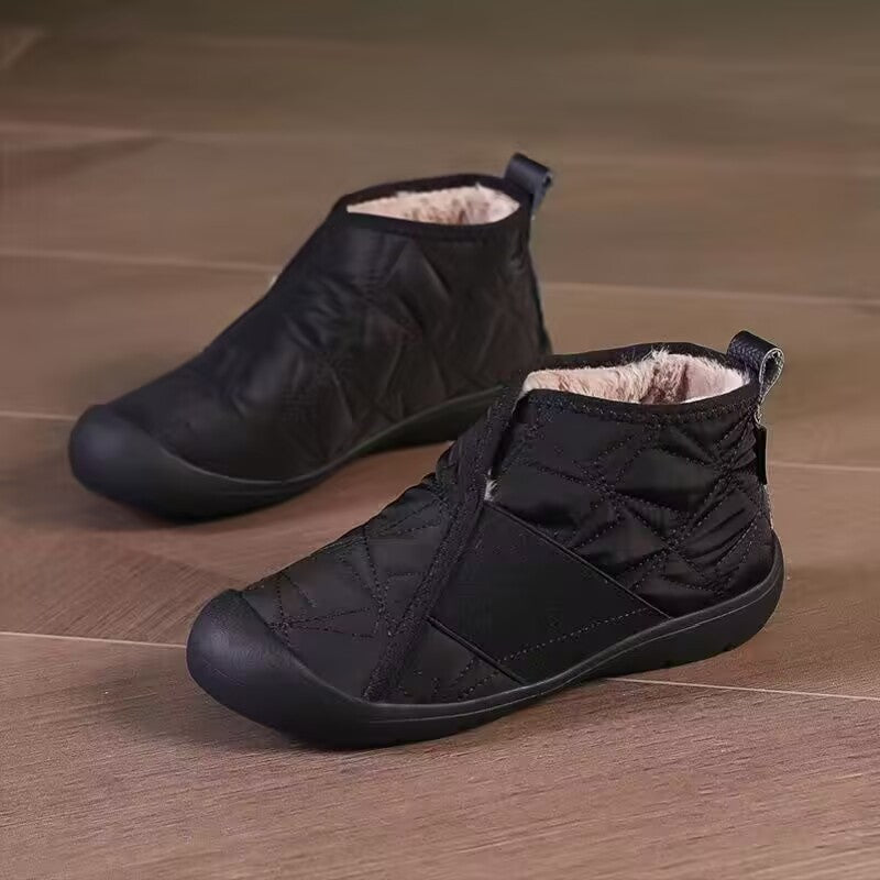 Black quilted ankle snow boots with fleece lining, elastic collar, and flat non-slip sole