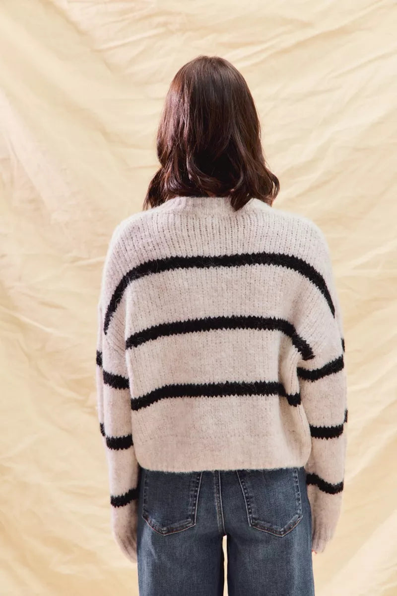 Back view: cream knit cardigan with black horizontal stripe bands and button front
