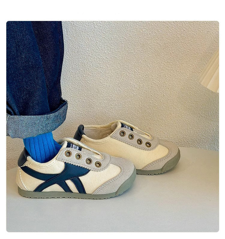 Kids casual sneakers with white uppers and blue side stripe details, with beige back pair.