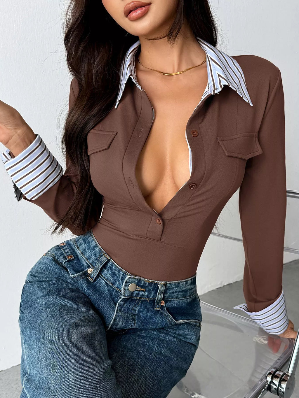 Brown button-front bodysuit with chest pockets and striped collar and cuffs