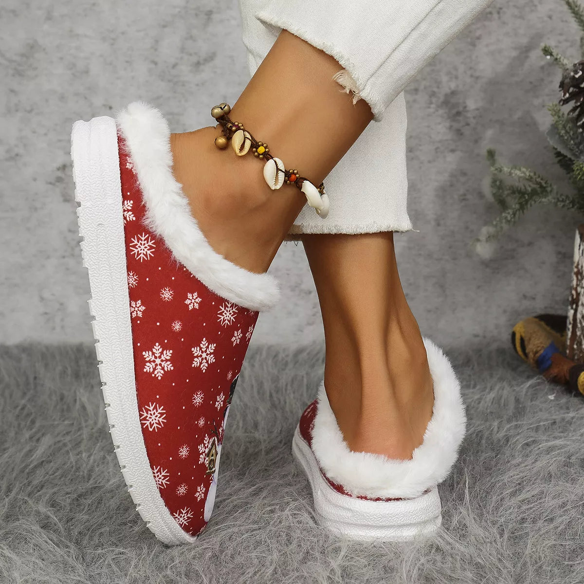 Red plush-lined slip-on slippers with snowflake pattern and white faux-fur trim