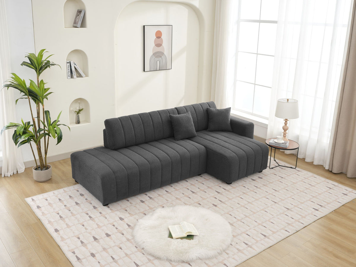Dark gray sectional sofa with chaise and rounded tufted back cushions