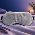 Grey weighted sleep mask with plush texture and curved eye opening