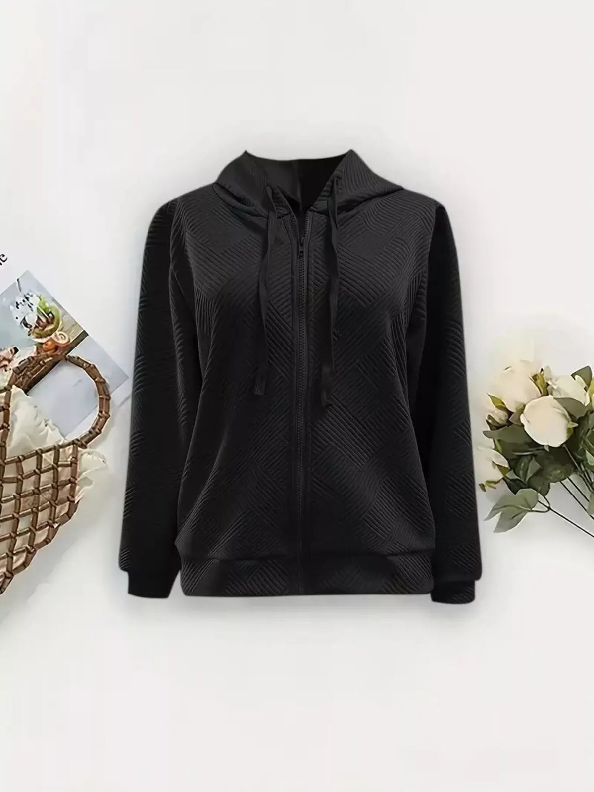 Black zip-up hooded jacket with textured chevron pattern and drawstring hood