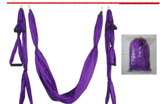 Purple yoga swing hammock with hanging fabric loops and straps