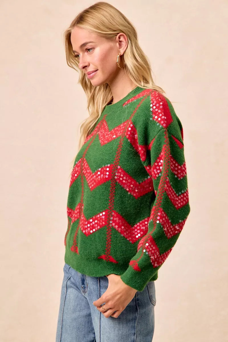 Green chevron knit sweater with red sequin zigzag detail, side view