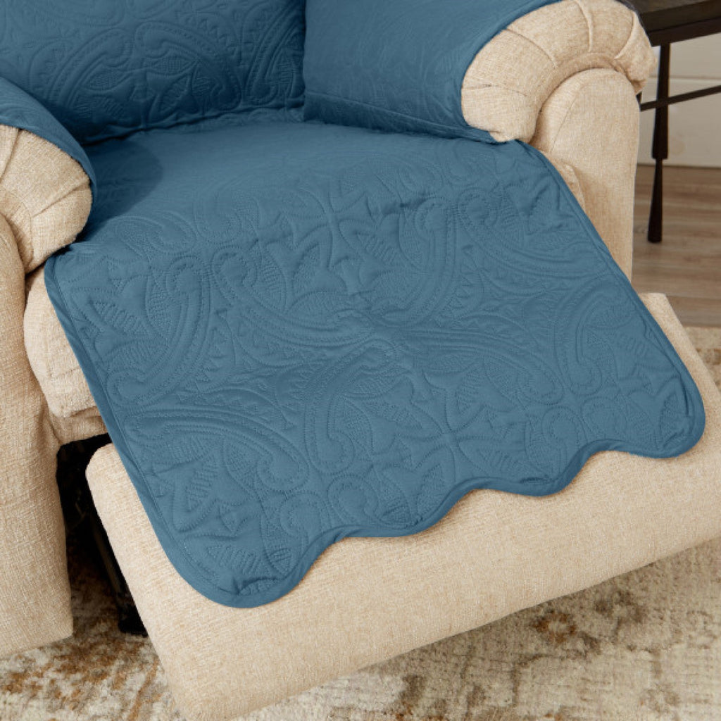 Blue quilted recliner protector cover with scalloped edge over chair seat