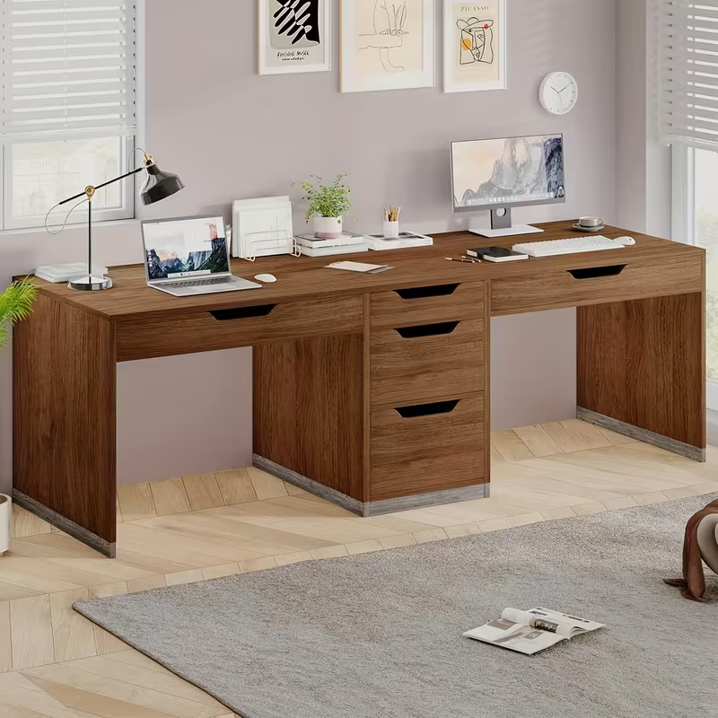 Brown two-person desk with central cabinet and two under-top keyboard drawers.