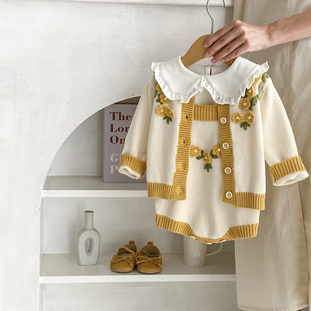 White baby coat with ruffle collar, mustard buttons, floral appliques, long sleeves