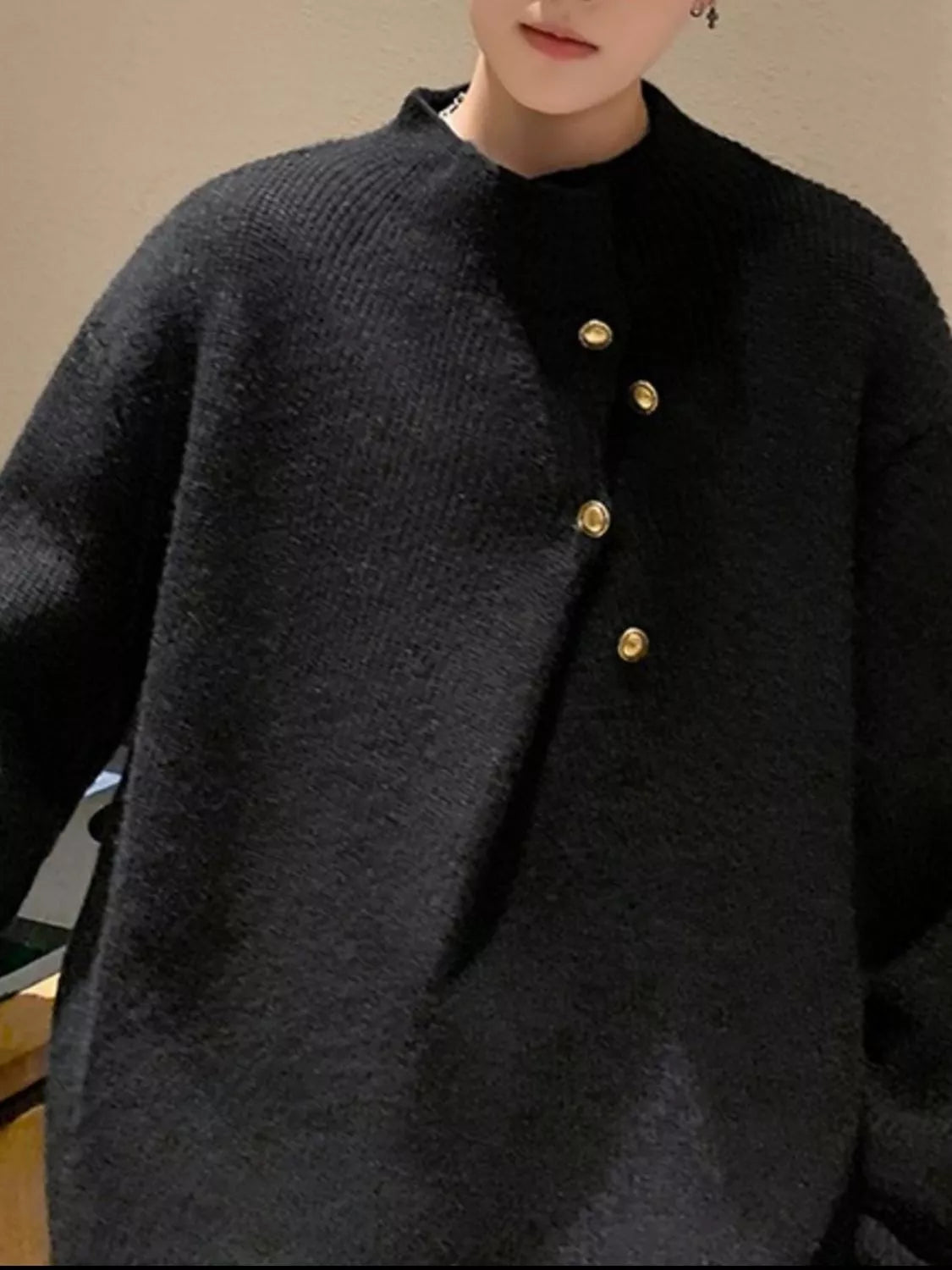 Men's black knitted sweater with crew neck, long sleeves, and gold-tone buttons