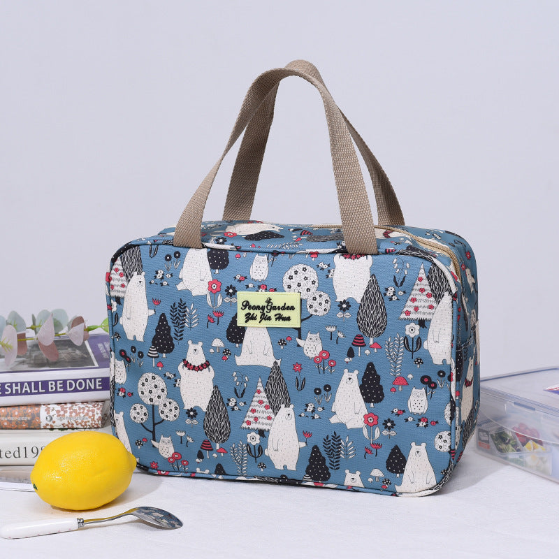 Blue travel toiletry bag with woodland animal print, top handle and zip closure