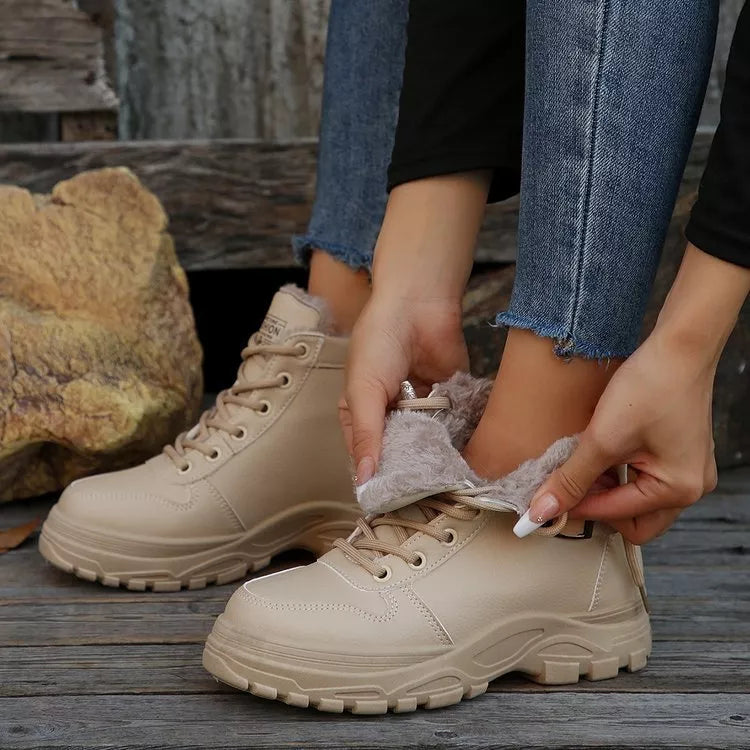 Beige warm-lined ankle boots, lace-up front and padded collar visible