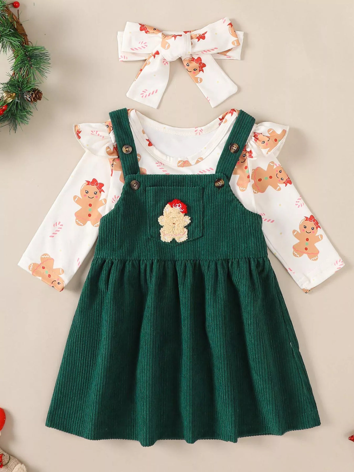 Green corduroy overall dress with reindeer applique over gingerbread print bodysuit