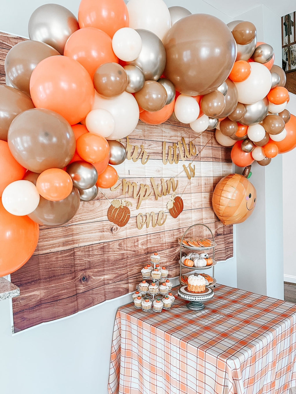Woodland fall balloon garland kit with dense fall balloon cluster and wooden banner panel