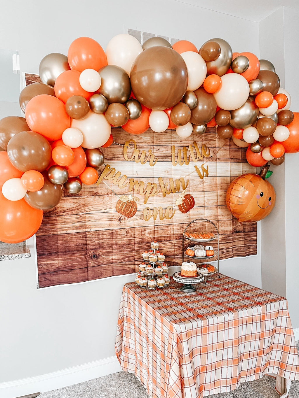 Woodland fall balloon garland kit with rounded balloon arch and small pumpkin decoration