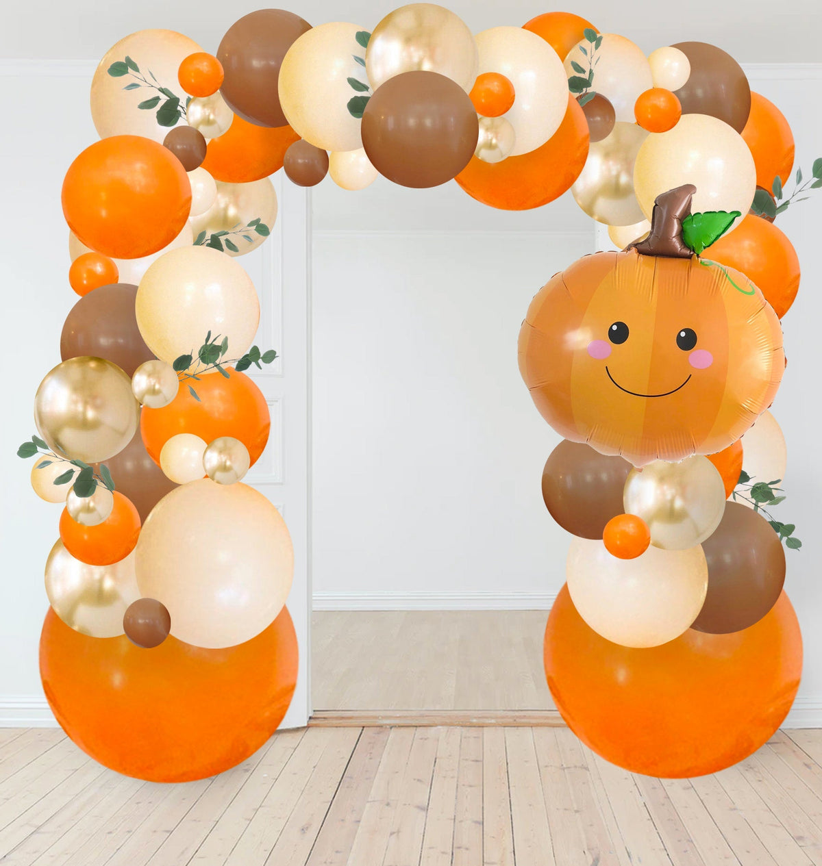 Woodland fall balloon garland kit with tall orange balloon arch and smiling pumpkin balloon