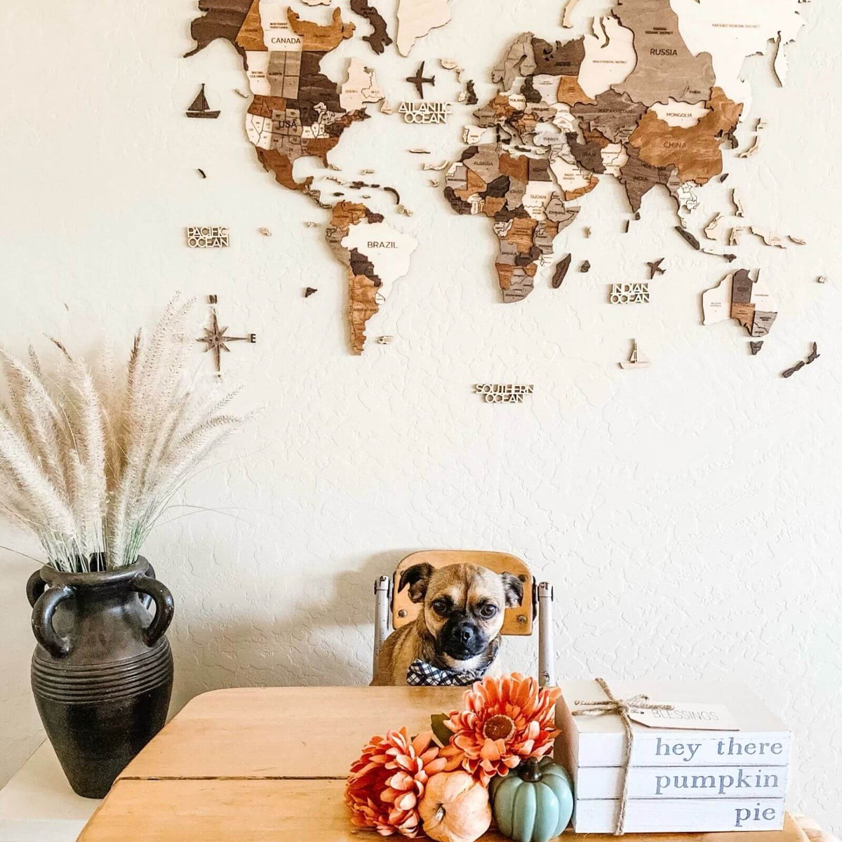 Wooden world map wall decor puzzle pieces with labeled regions, mounted on wall