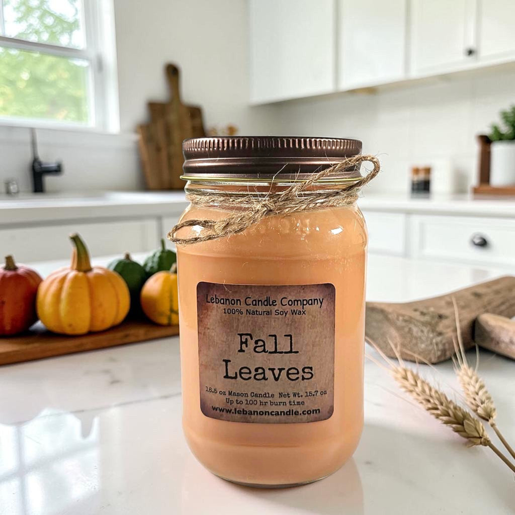 Amber jar candle with twine-wrapped lid, front label reading “Fall Leaves”