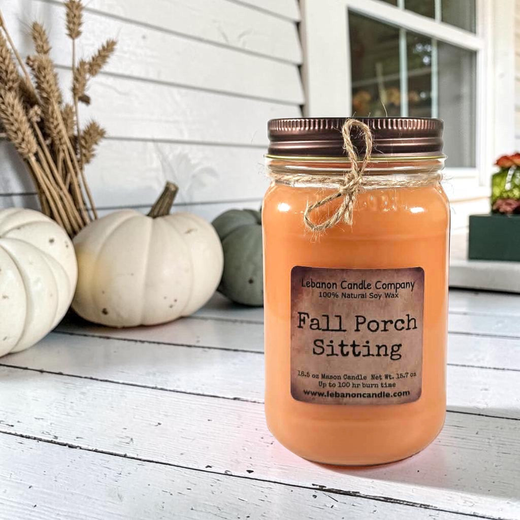 Fall Porch Sitting soy wax candle in amber jar on white porch boards