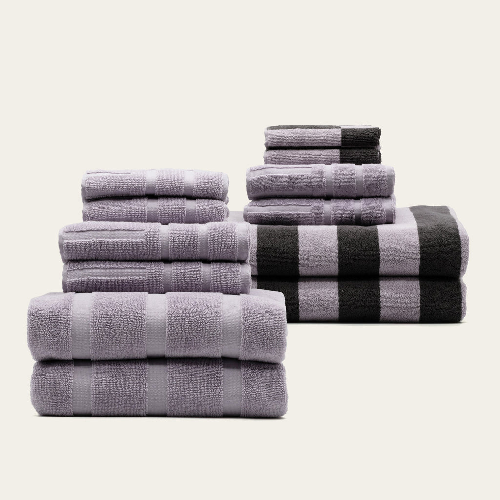 Cotton towel set with lavender towels and black-and-white striped bath towel