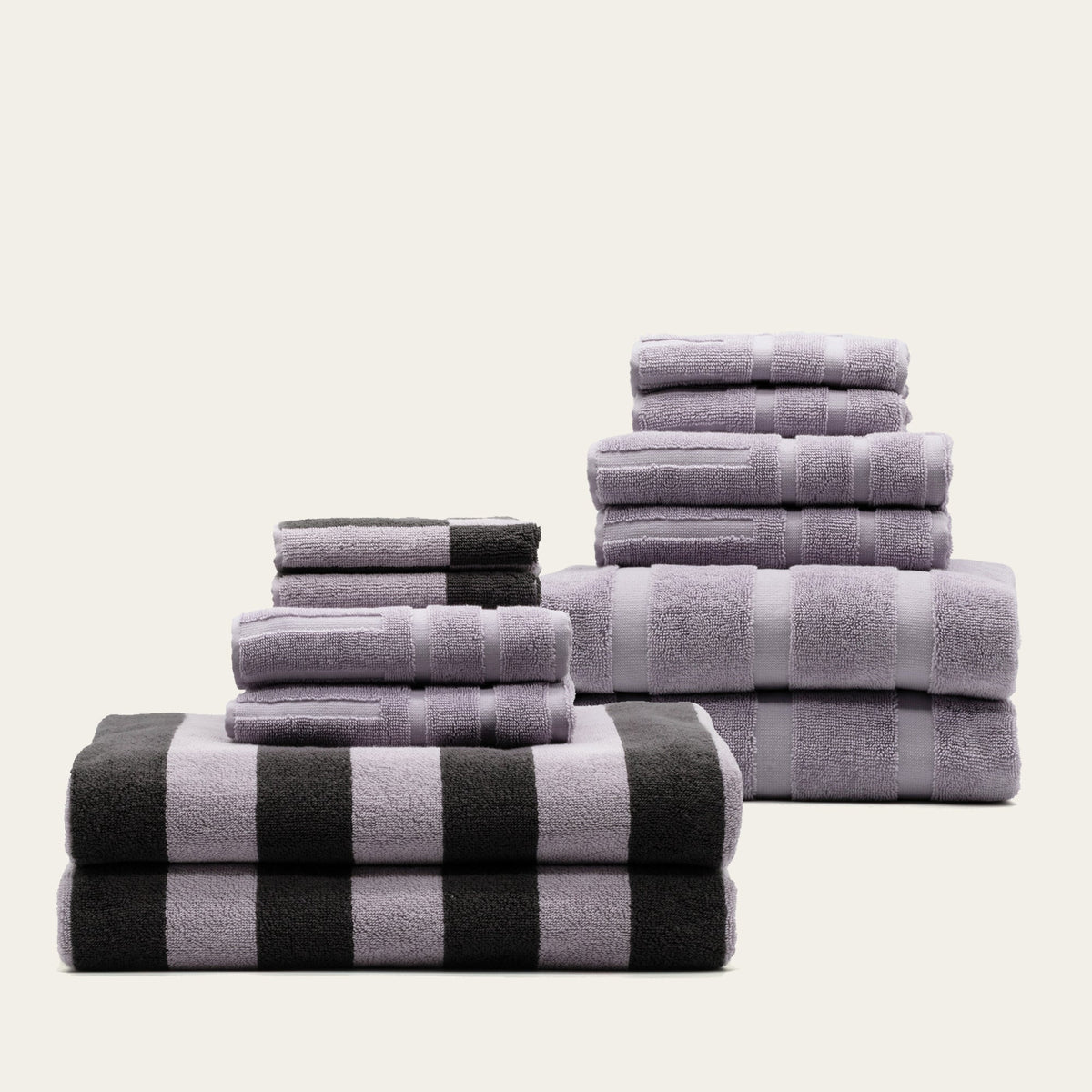Australian cotton towels stack in lilac-gray with striped accents, neatly folded
