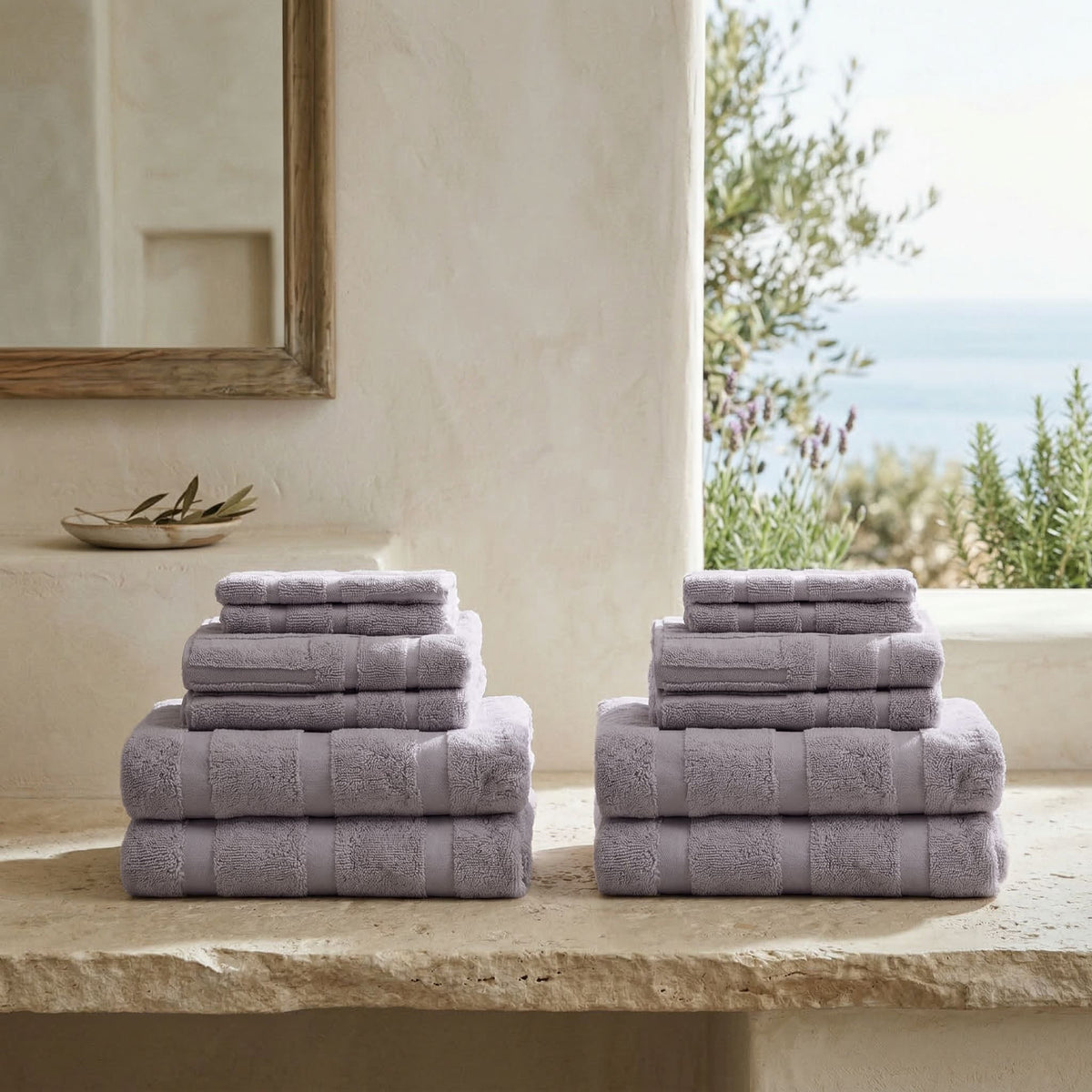 Stacked lilac cotton towels with textured stripe detailing