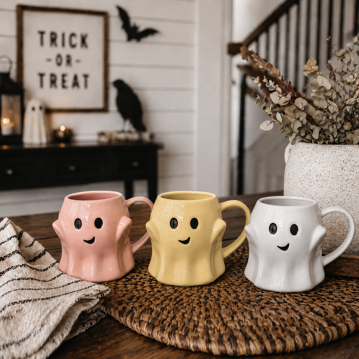 Set of three ghost mugs, pink, yellow, and white with smiley faces