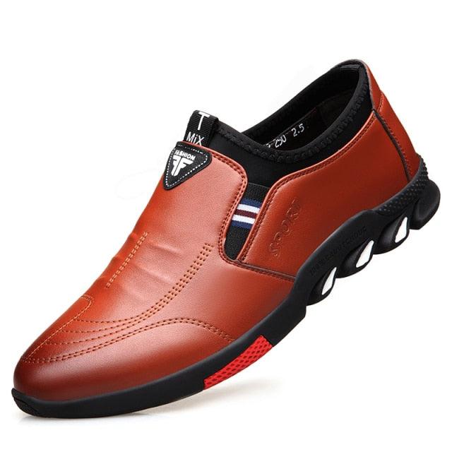 Men's brown slip-on leather shoes with black side panels and red-accent outsole