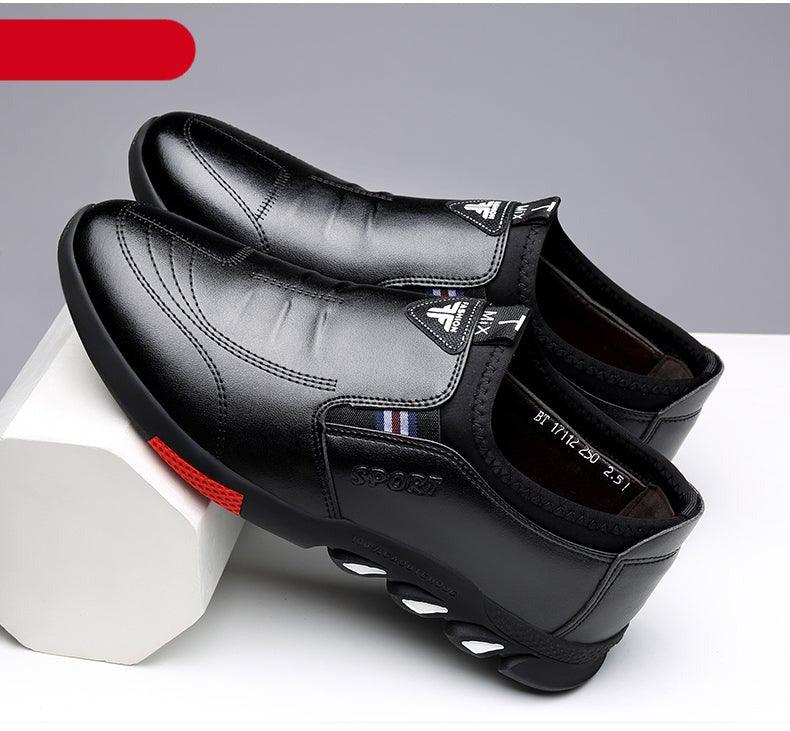 Men's black slip-on leather shoes with curved stitching and treaded outsole