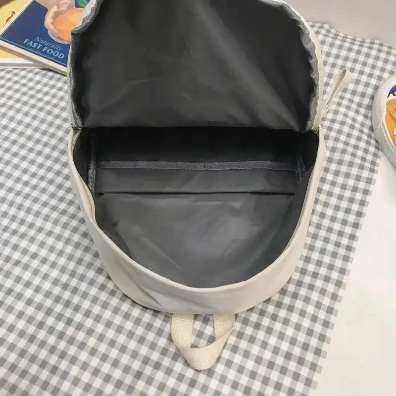 Black backpack open at top, showing padded interior