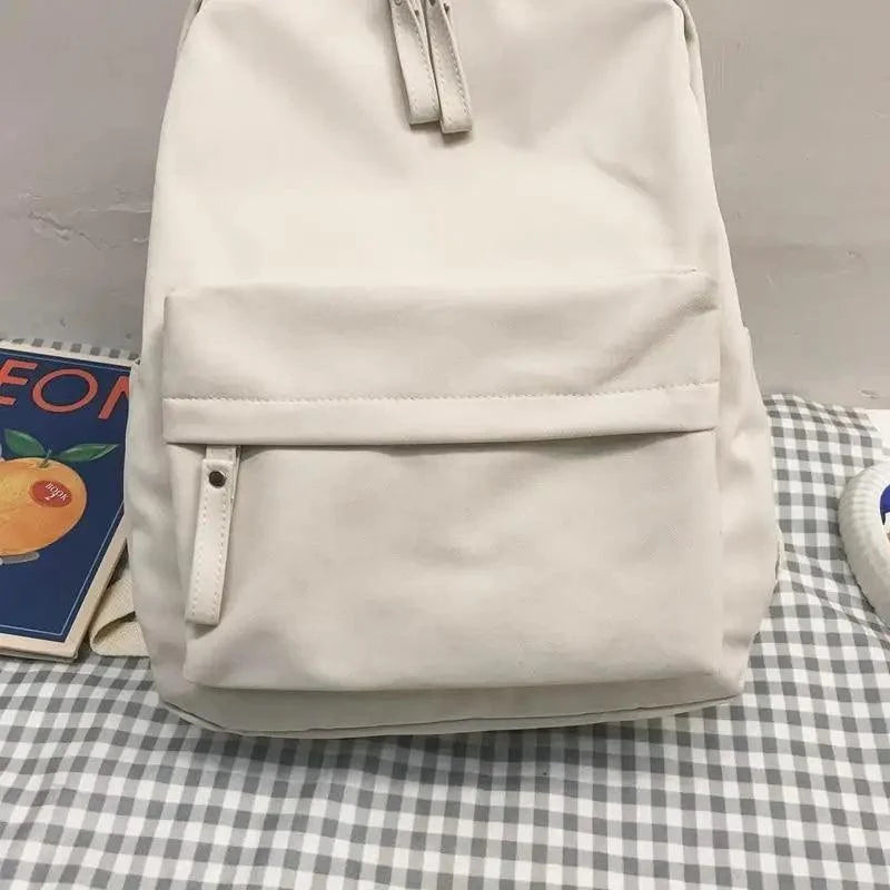 Off-white backpack with front flap pocket and side strap tabs