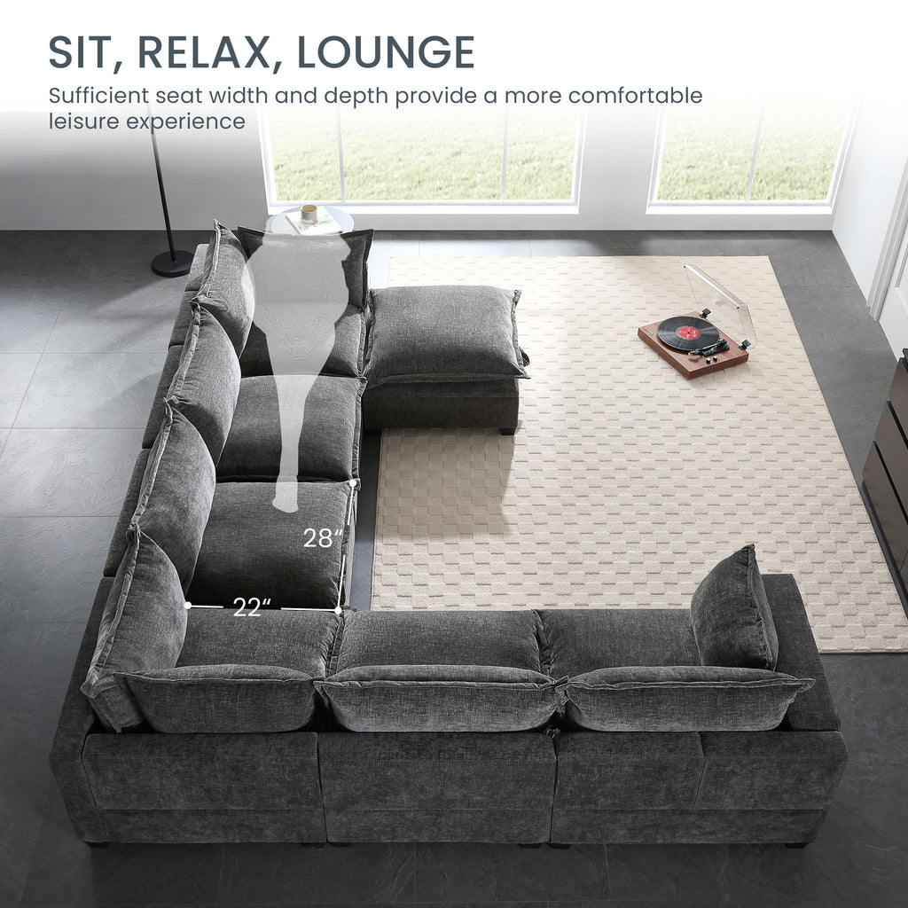 Dark gray chenille modular sectional sofa with movable storage ottoman and throw pillows.