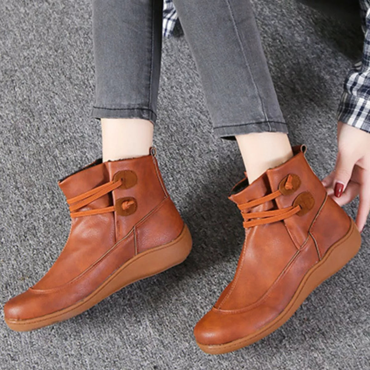 Caramel lace-up ankle boots with round button detail and tan outsole