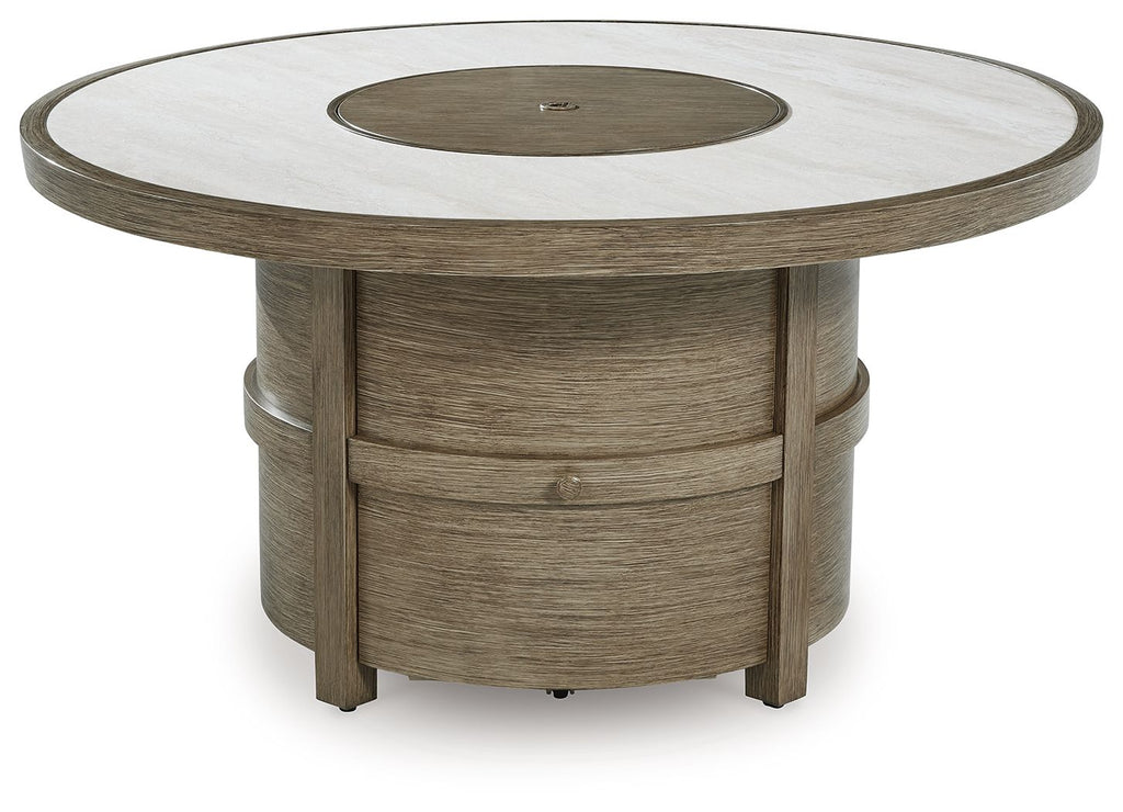 Round fire pit table with beige tabletop, dark burner cover, and sturdy wood legs