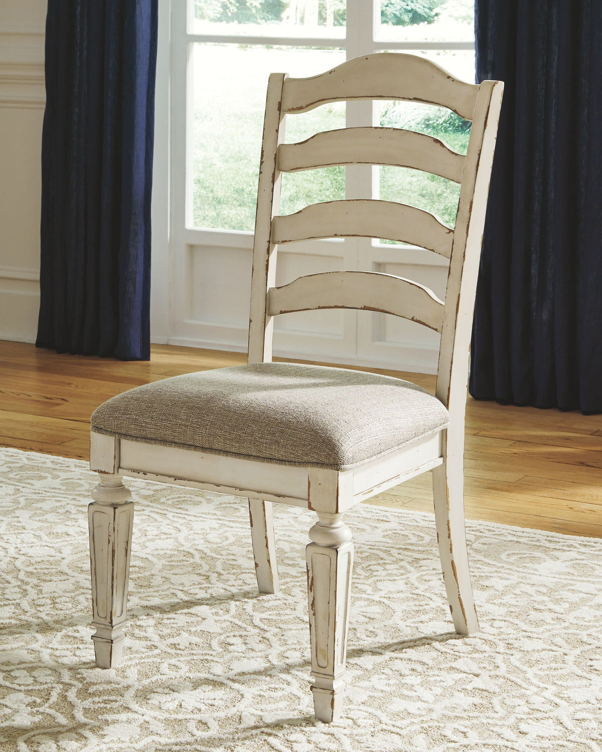 White wood ladderback dining chair with upholstered beige seat cushion and back slats