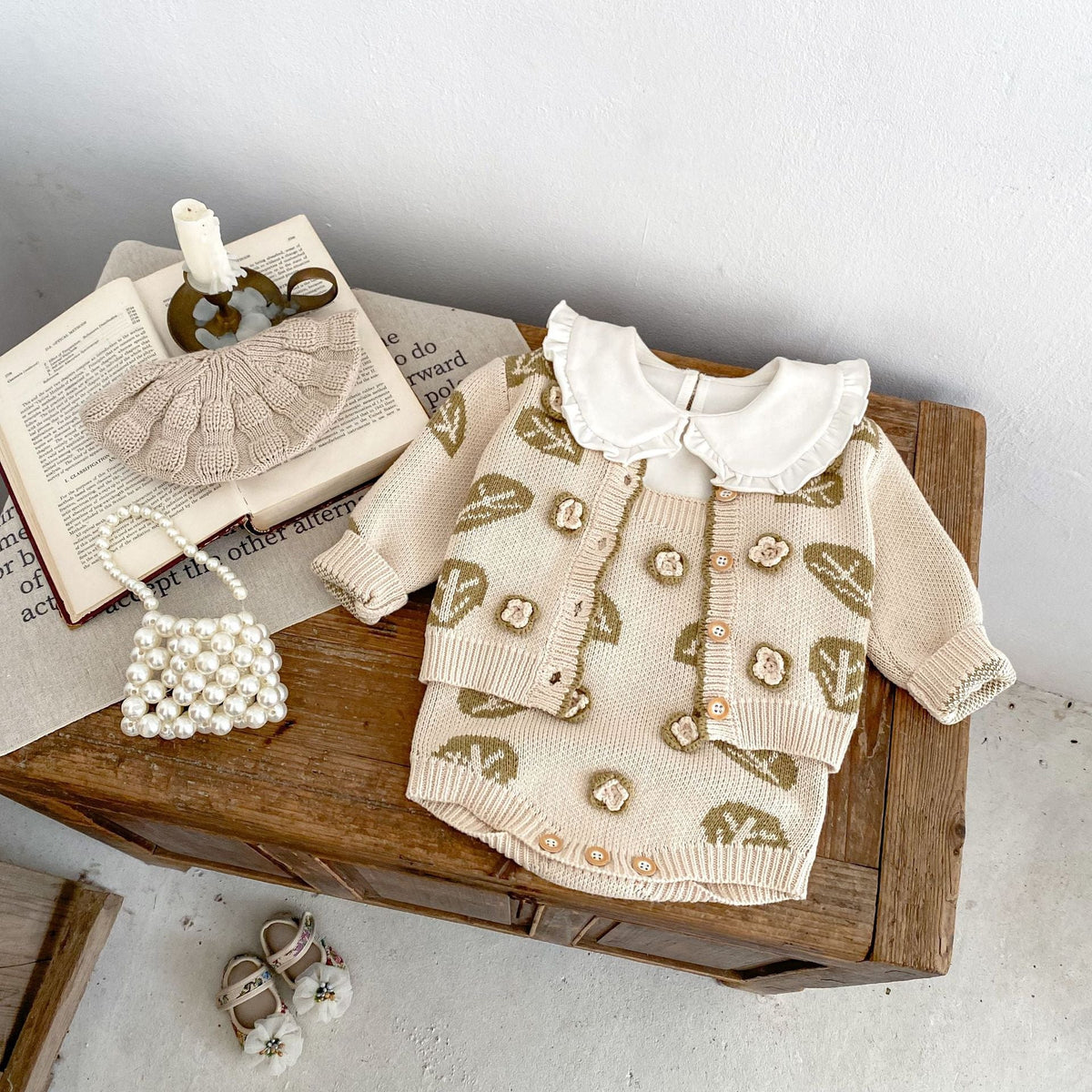 Cream leaf-jacquard cardigan sweater with button front and matching suspender skirt set