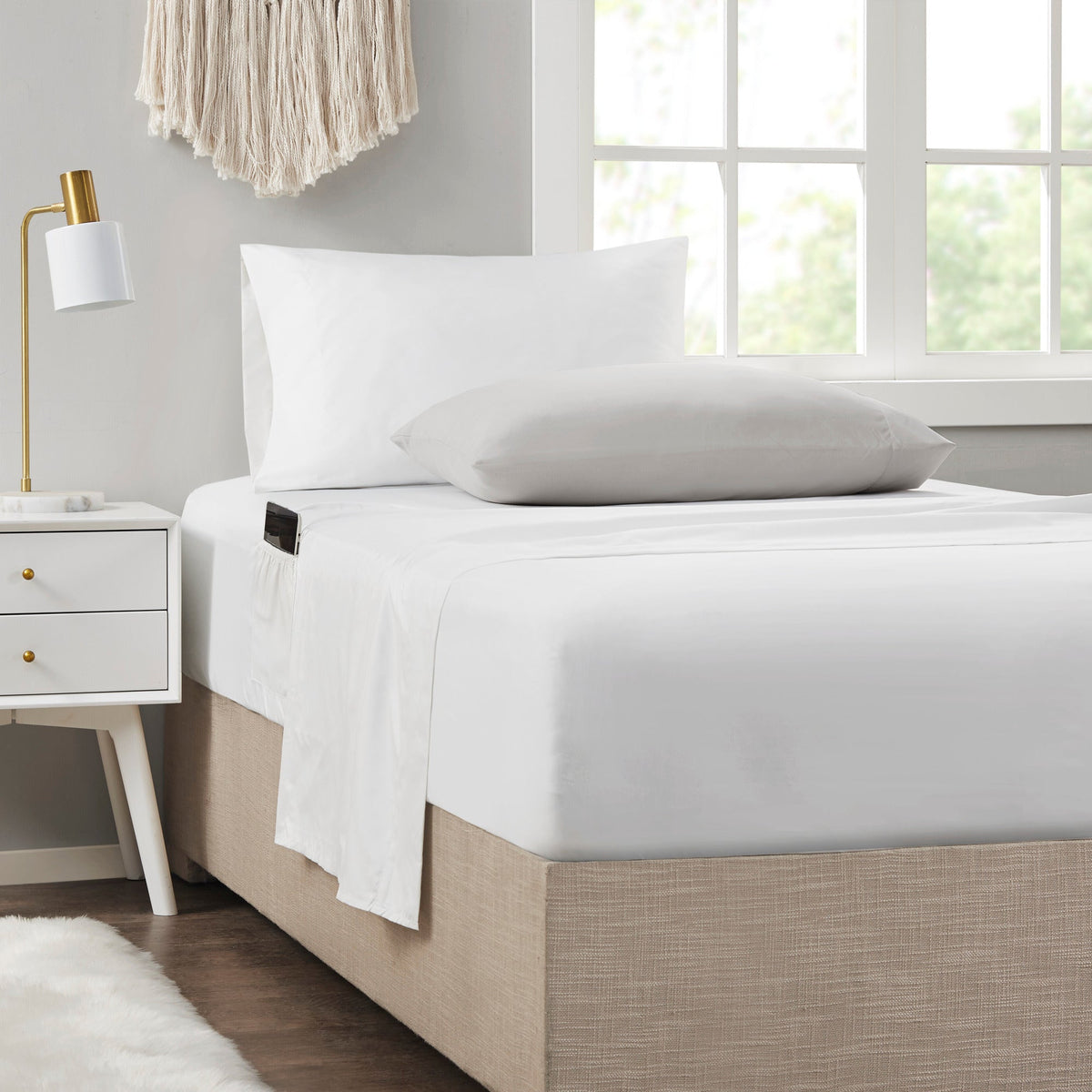 Twin XL white sheet set with two pillows and comforter cover, clean made bed view